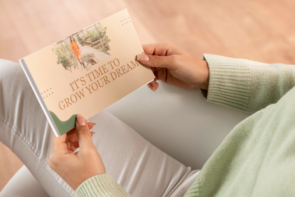 Hands holding a printed marketing flyer with custom design